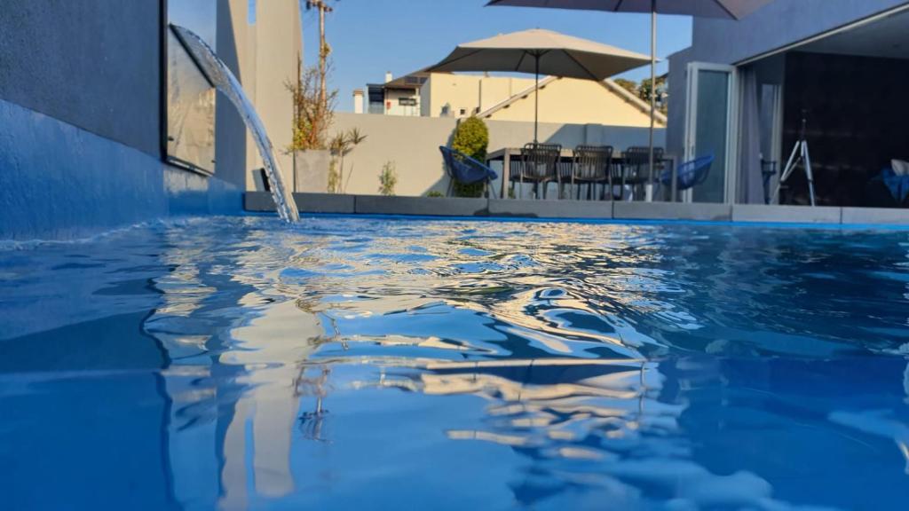 a swimming pool with blue water in a house at Marble Blue in Cape Town