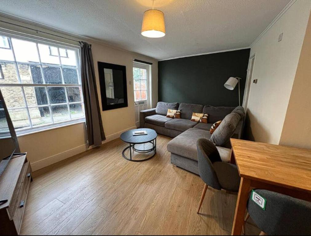 a living room with a couch and a table at Spacious St Helens By Prescott Apartments in Abingdon