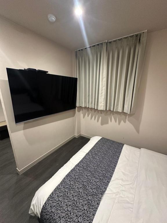 Postel nebo postele na pokoji v ubytování Aank Ryokan Hotel Paju
