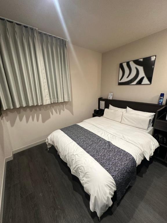 Postel nebo postele na pokoji v ubytování Aank Ryokan Hotel Paju