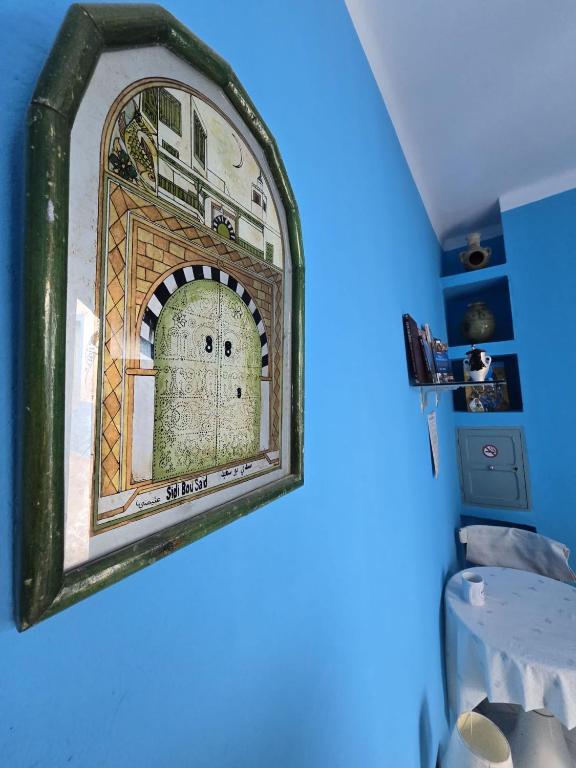 a framed picture of a door on a wall at Dar Hkaïem in Sousse