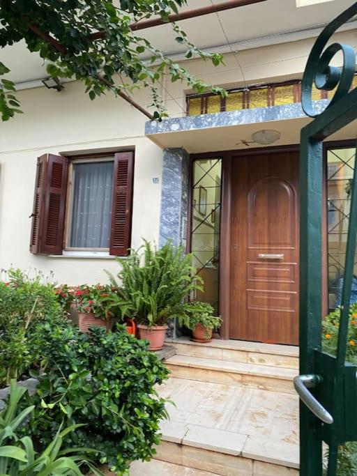 a front door of a house with potted plants at Sandras apartment in Igoumenitsa