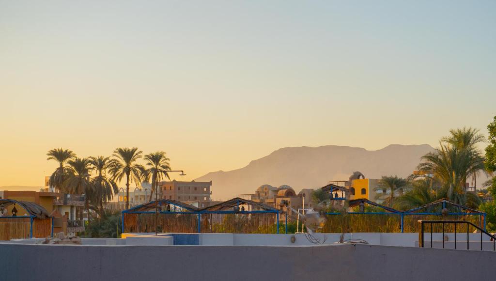 a city with palm trees and mountains in the background at Akhenaten Apartments in Luxor