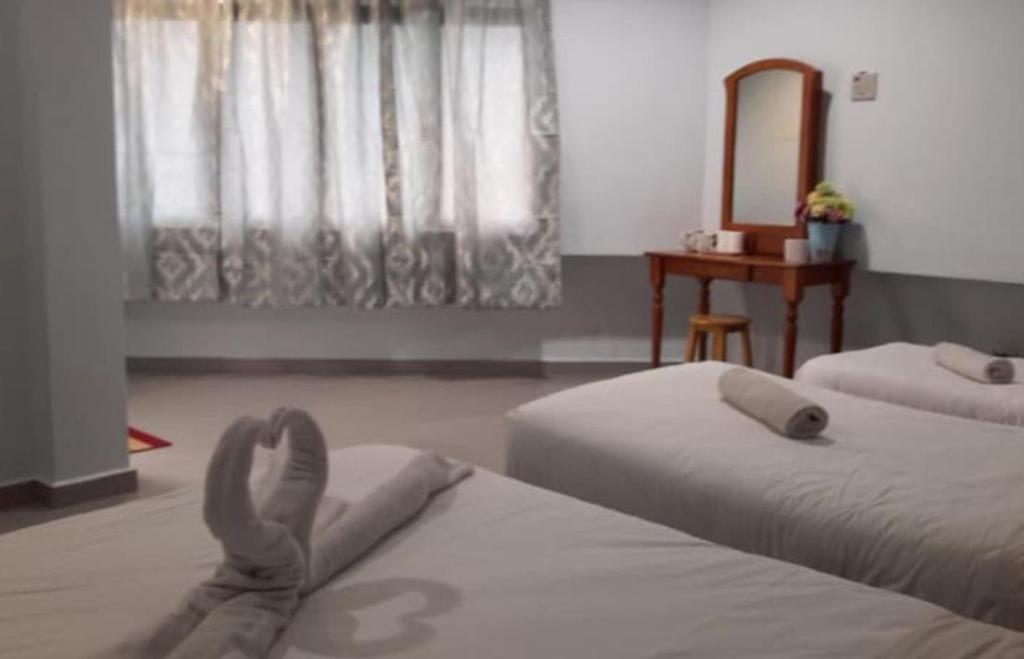 Postel nebo postele na pokoji v ubytování M Straits Hotel