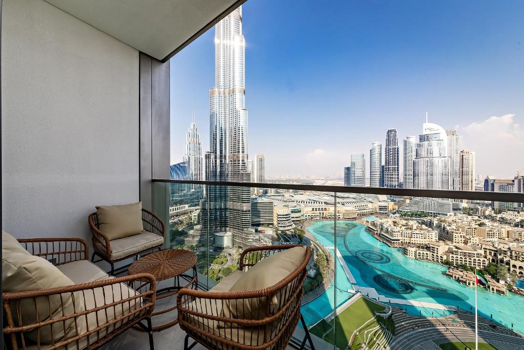 a balcony with chairs and a view of a city at Prime Burj Khalifa&Fountain Views 2 Bdr Apartment in Dubai