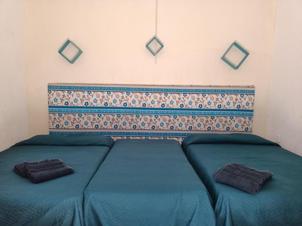 Postel nebo postele na pokoji v ubytování Casona Luciérnaga-Casa de Huéspedes