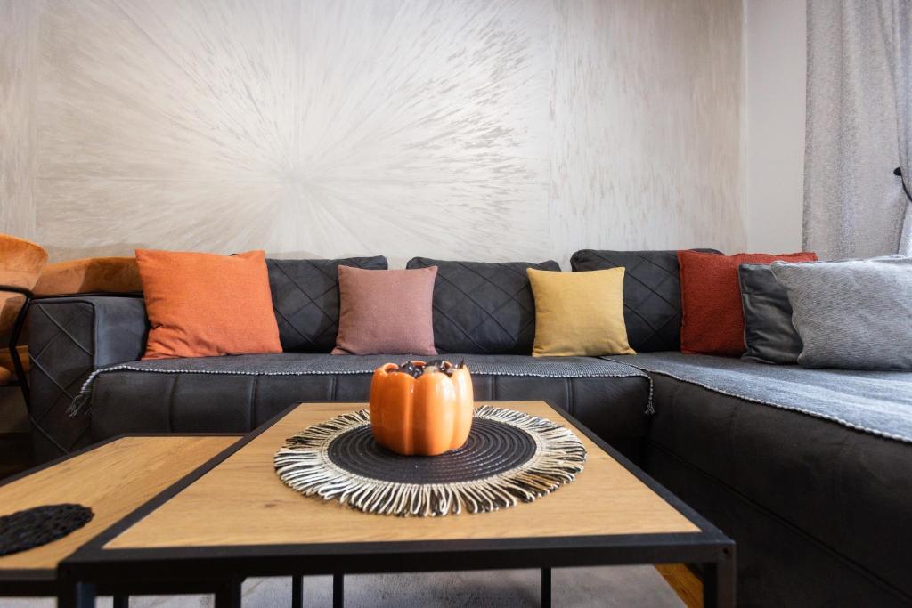 a living room with a couch with a pumpkin on a table at stan na dan AURORA in Požarevac