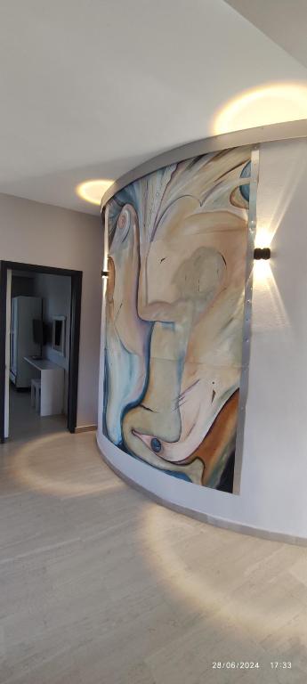 a painting hanging on a wall in a room at olivegrove in Sidari