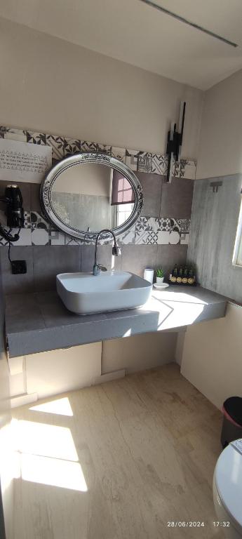 a bathroom with a sink and a mirror at olivegrove in Sidari