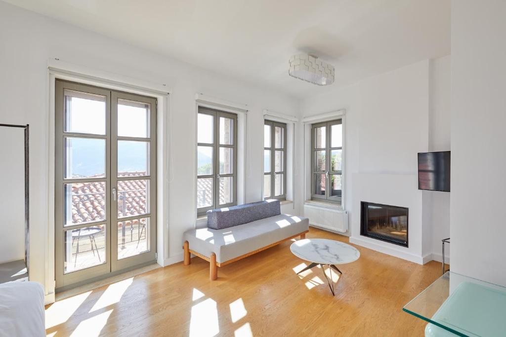 a living room with a couch and a fireplace at Clock Tower Arachova in Arachova