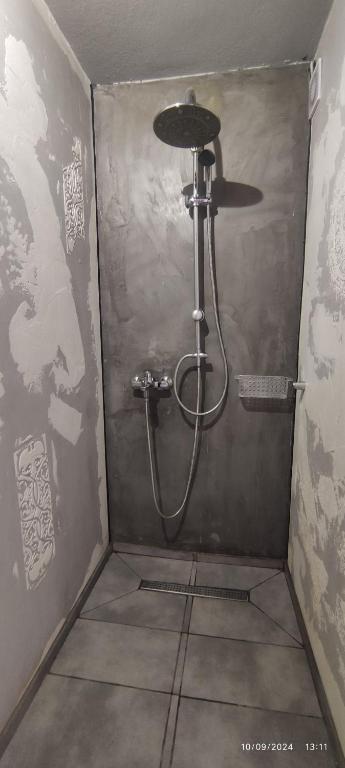 a shower in a corner of a bathroom at olivegrove in Sidari