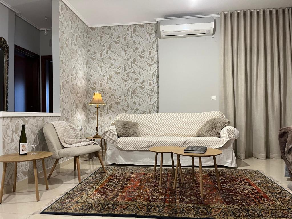 a living room with a couch and a table at Adagio, JIMA winery luxury apartments in Ioannina