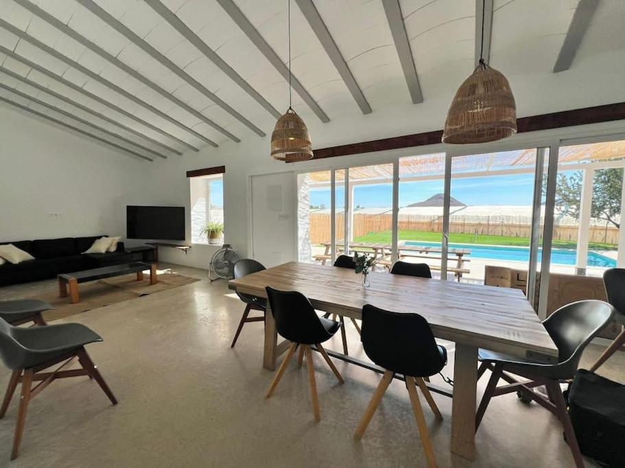 a living room with a wooden table and chairs at Casa de la Abuela, a estrenar! escapada Rural in Mazarrón