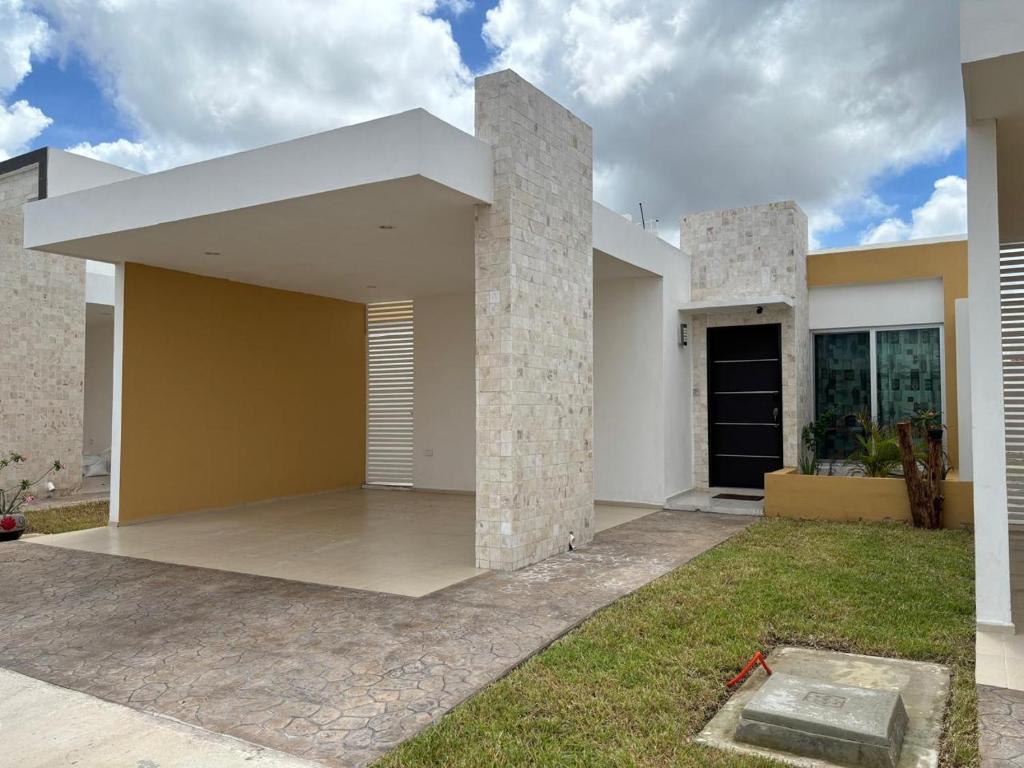 a large white house with a yard at In Wotoch in Cancún
