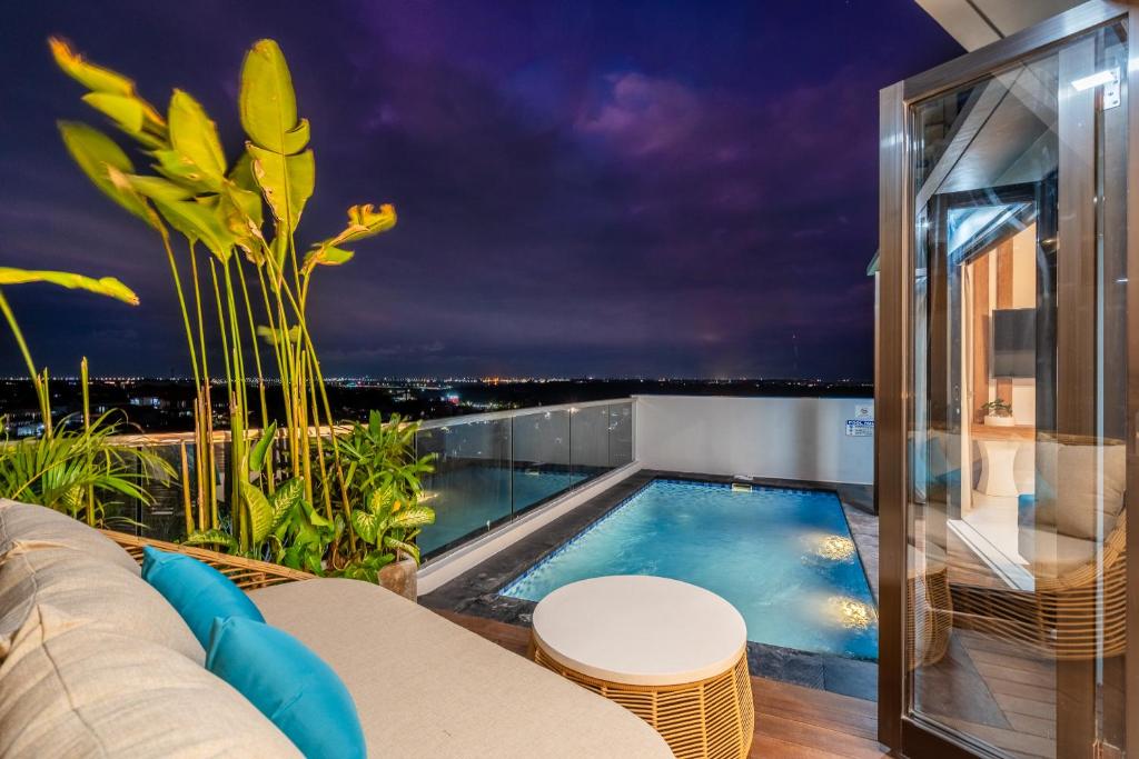 a swimming pool on the roof of a house at The Peak - 2BR Luxury Hill Villa Nusa Dua in Nusa Dua