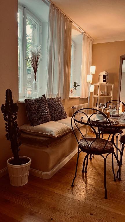a living room with a couch and a table at Apartment am Schloss - FLAIR in Saarbrücken
