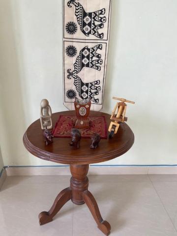 a small table with figurines on top of it at Hayes Court Luxury Apartments in Meetotamulla