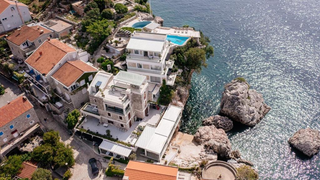 an aerial view of a house by the water at Blanche Cliff Apartments in Sveti Stefan