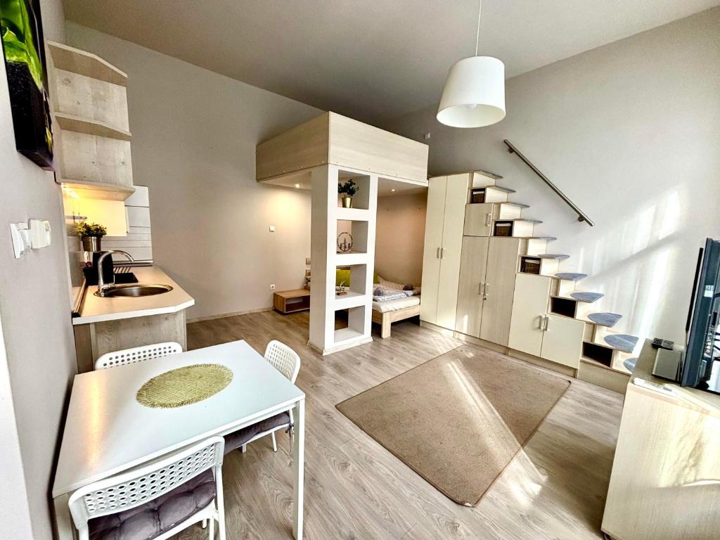 a small room with a kitchen and a staircase at Ava Central Residence in Budapest