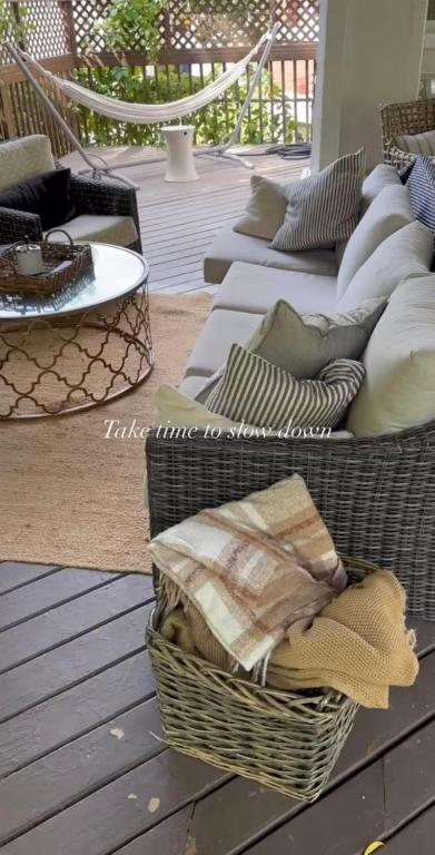 a patio with two couches and a basket of pillows at No. 5 East in Winnipeg
