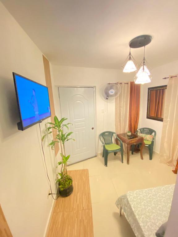 a living room with a tv on a wall at Blue Sky 101 in Santo Domingo