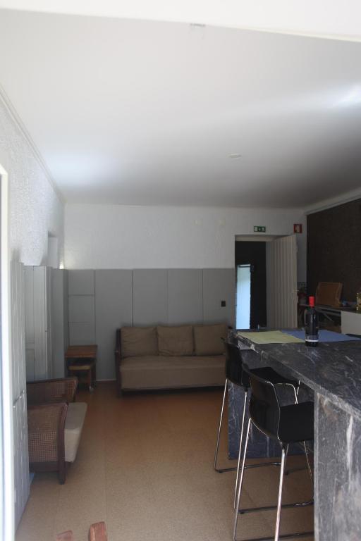 a living room with a couch and a table at ribeira dos marinheiros amarelo in Sintra