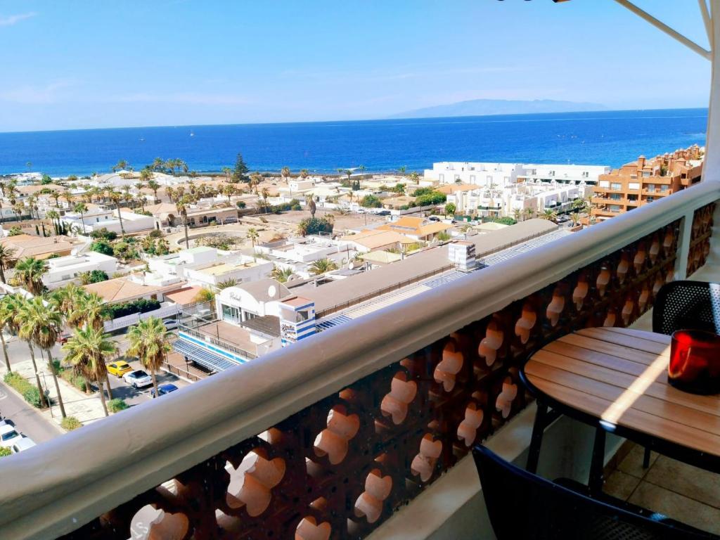 a balcony with a view of a city and the ocean at Palm-Mar Penthouse Celeste vue mer panoramique 200m de l'océan in Palm-Mar
