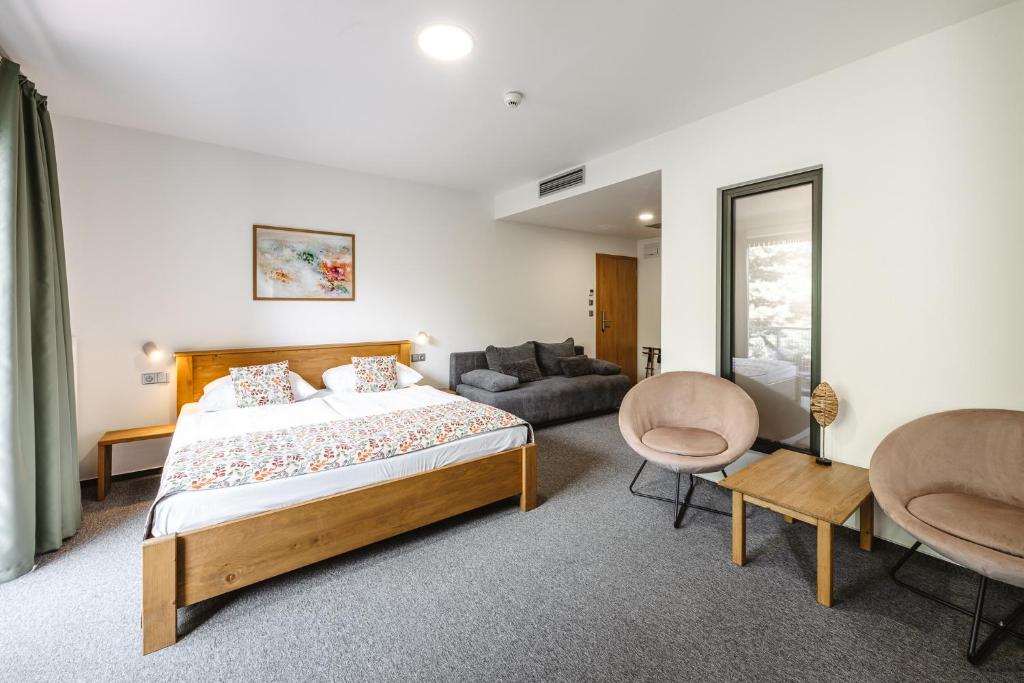 Postel nebo postele na pokoji v ubytování Hotel Frýdl