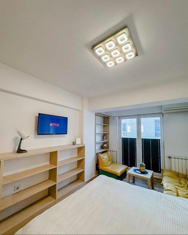 a room with a bed and a tv and a couch at Calvin Apartment 10 in Ohrid