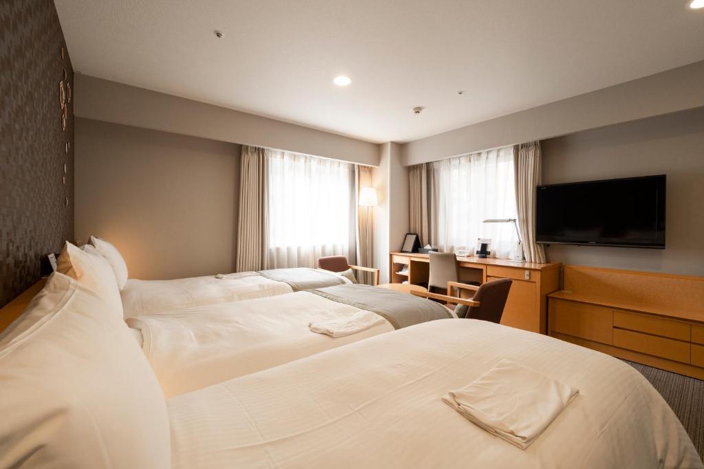 Tempat tidur dalam kamar di Richmond Hotel Sapporo Ekimae