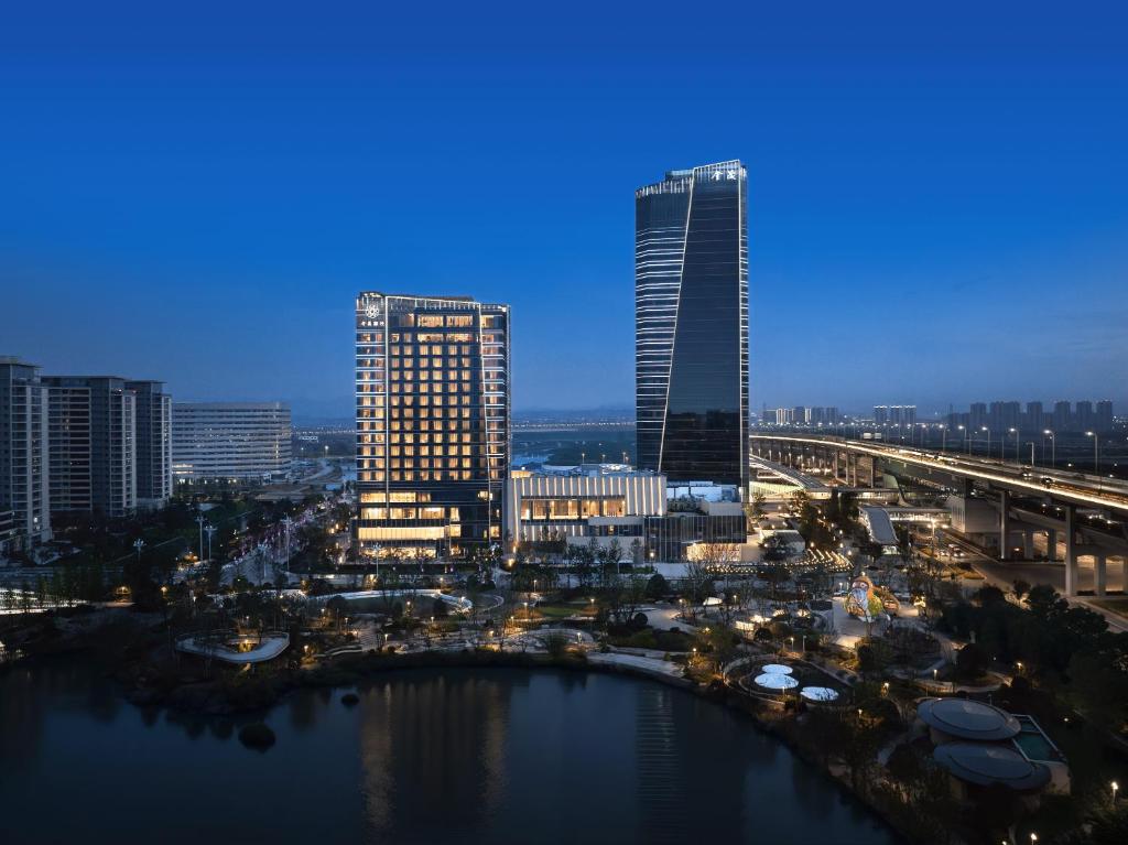 a view of a city with tall buildings and a river at Jinmao Grandee Hotel Ningbo in Fenghua