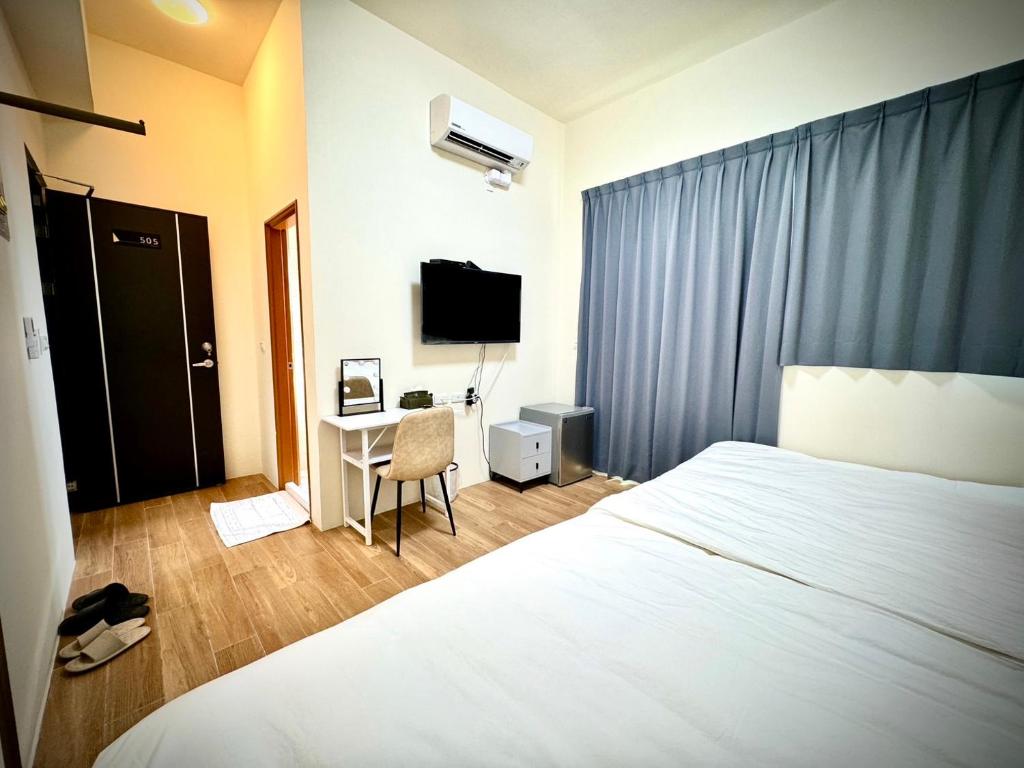 Postel nebo postele na pokoji v ubytování Huatian B&B