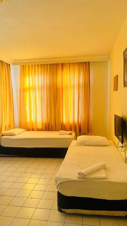 Postel nebo postele na pokoji v ubytování Baronessa Apart Hotel