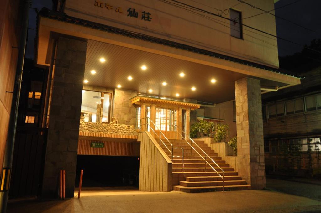 a building with stairs in front of it at night at Senso Yutagawa in Tsuruoka