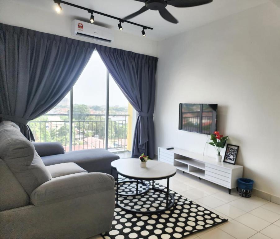 a living room with a couch and a table at Malacca Spacious 3Bedroom Wifi Carpark in Malacca