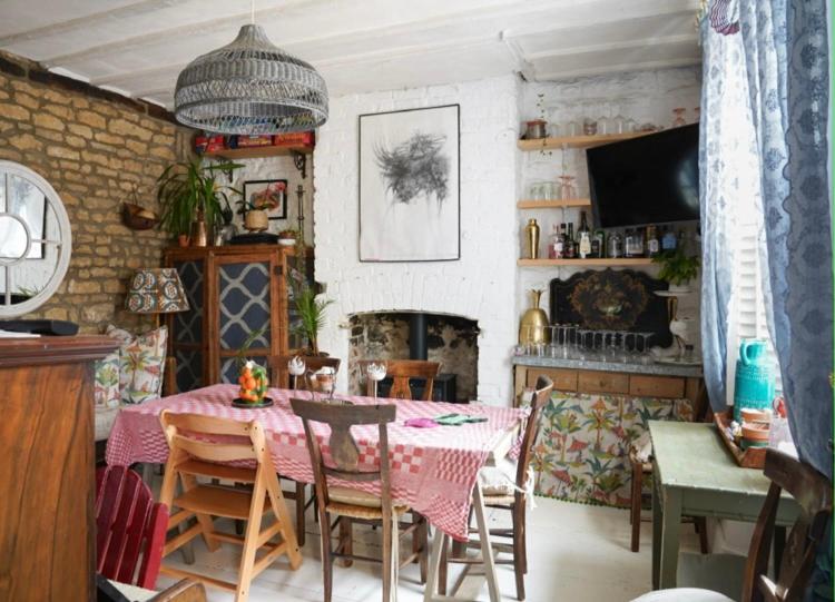 a dining room with a table and a fireplace at Stamford Lodge in Stamford