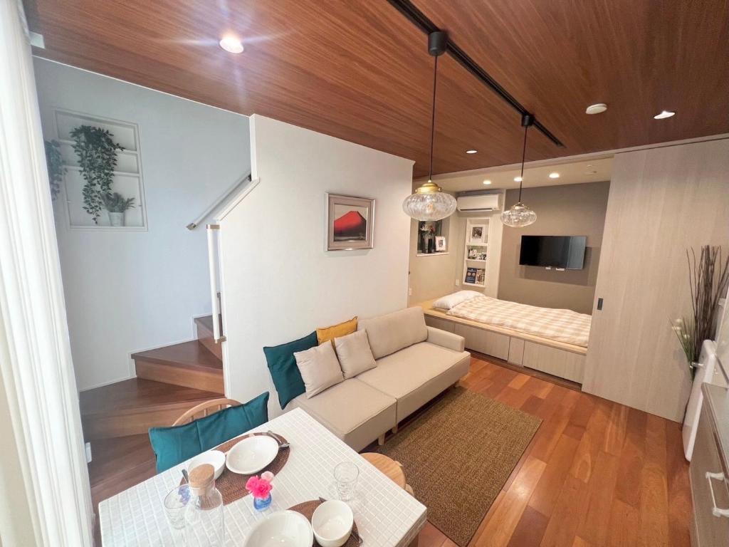 a living room with a couch and a table at Honancho Entire house for rent 東京 in Tokyo
