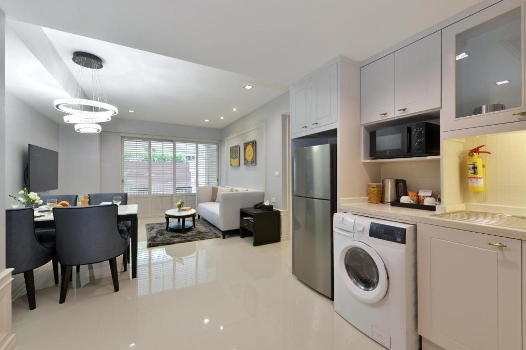 An open-plan kitchen, dining area and living room include a washer-dryer.