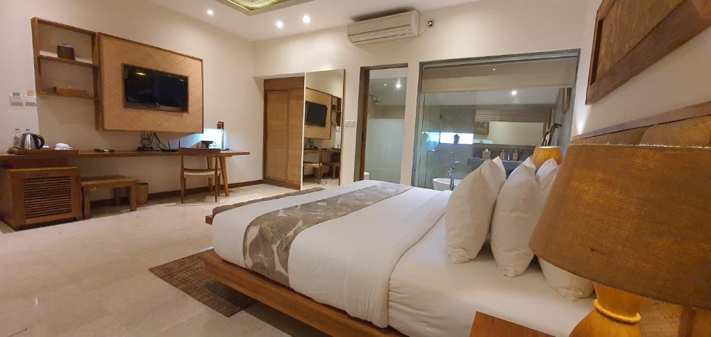 Letto o letti in una camera di Purana Suite Ubud