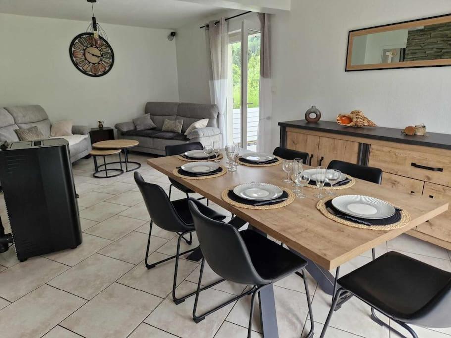 a living room with a wooden table and chairs at Chez Katy in Ban-sur-Meurthe-Clefcy