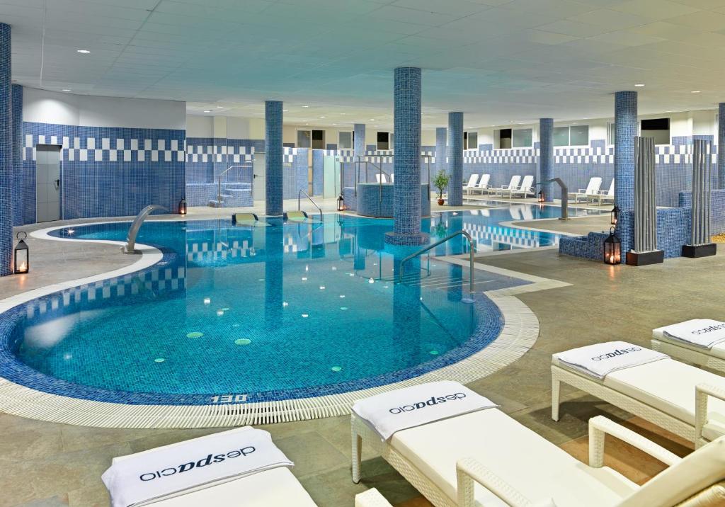 a large swimming pool in a hotel lobby at H10 Estepona Palace in Estepona