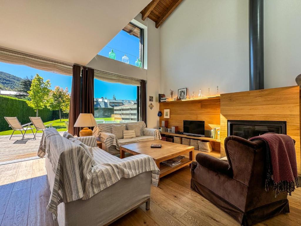 a living room filled with furniture and a fireplace at Morada la Tosa in Alp