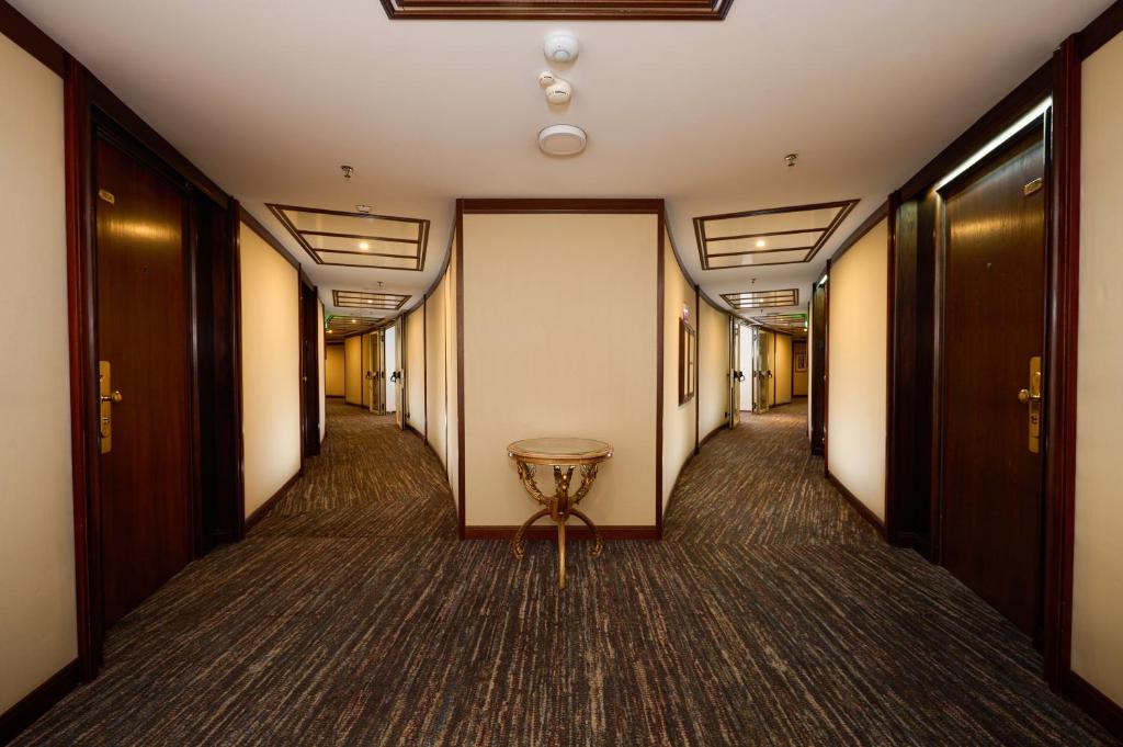 a corridor with a table in the middle of a hallway at Grand Hotel Bucharest in Bucharest
