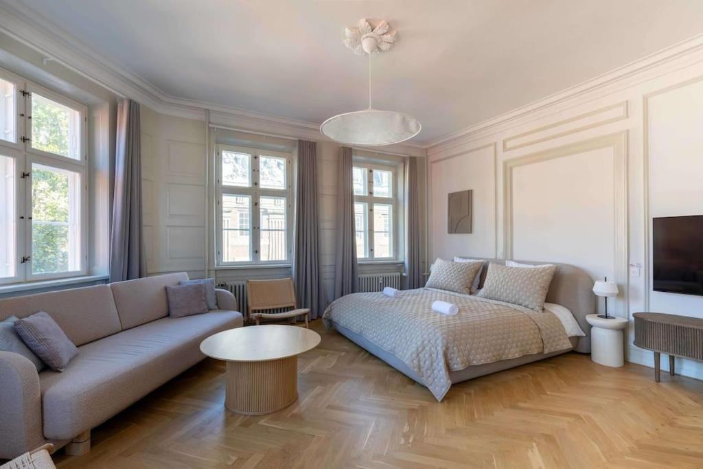 a living room with a couch and a table at Spacious Apartment on Lively & Vibrant Street in Copenhagen