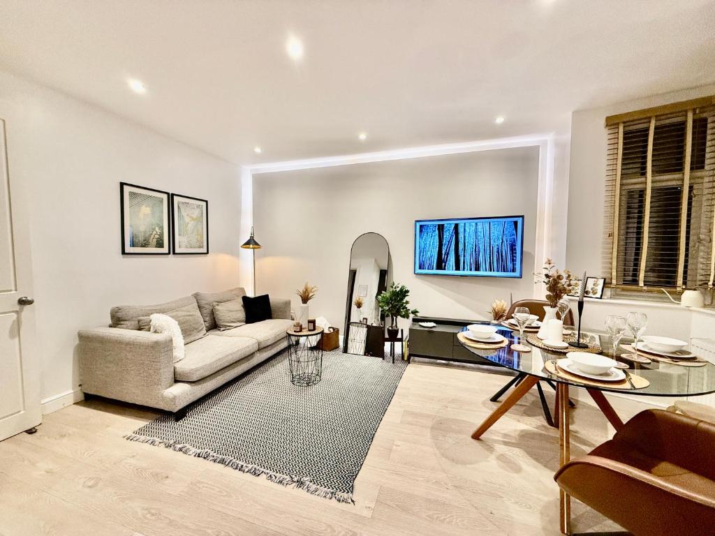 a living room with a couch and a table at Superb Duplex in Hendon in The Hyde