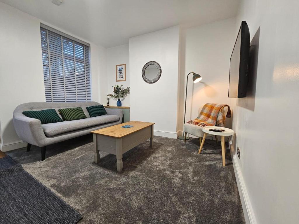 a living room with a couch and a table at Newly Renovated 2 Bed with Garden & Parking in Ipswich
