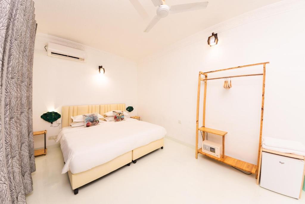 Postel nebo postele na pokoji v ubytování Fasdheythere Inn Maldives