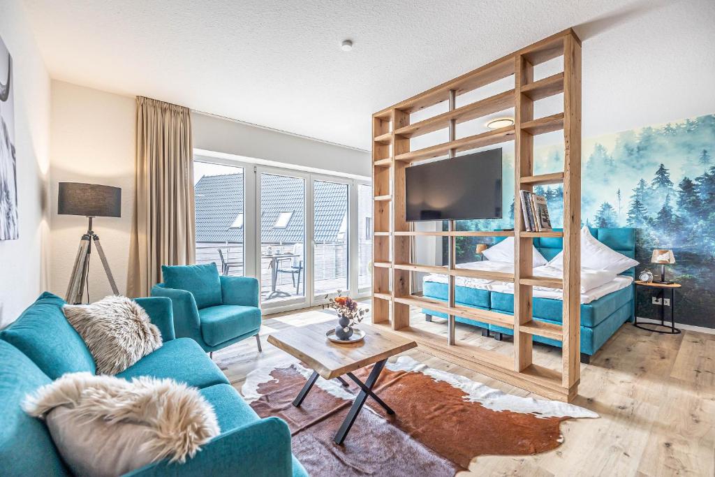 a living room with a bunk bed and a blue couch at Ferienwohnung Wiking-Koje 7 Schleswig in Schleswig