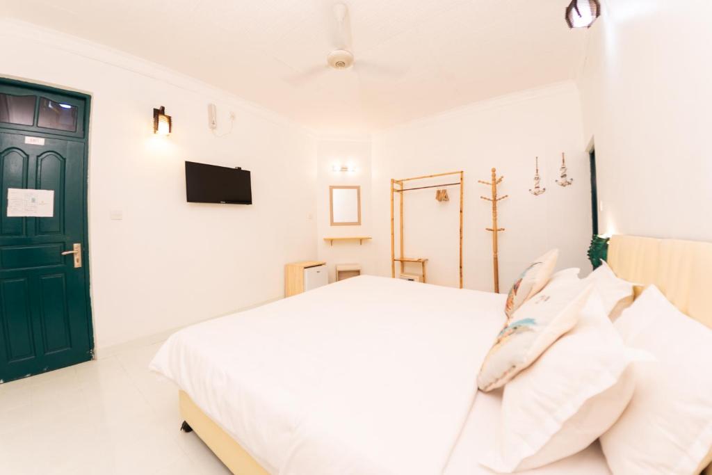 Postel nebo postele na pokoji v ubytování Fasdheythere Inn Maldives