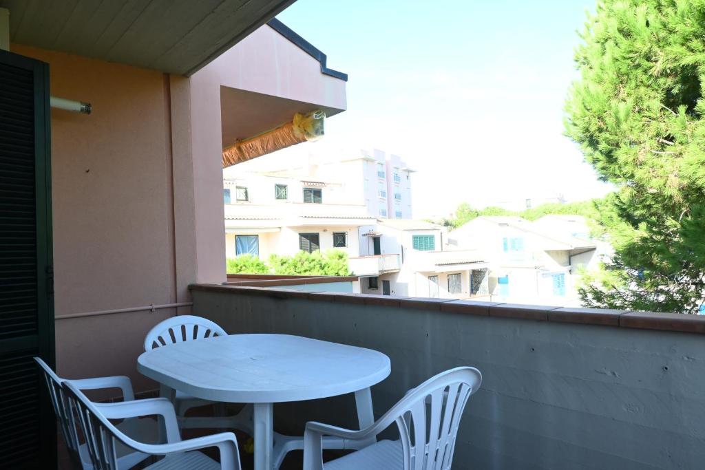 a white table and chairs on a balcony at M328 - Marcelli, bilocale con vista mare in Marcelli